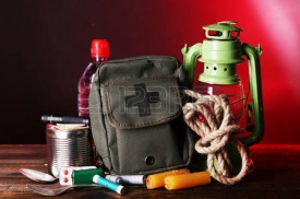 33209906-emergency-preparation-equipment-on-wooden-table-on-dark-background